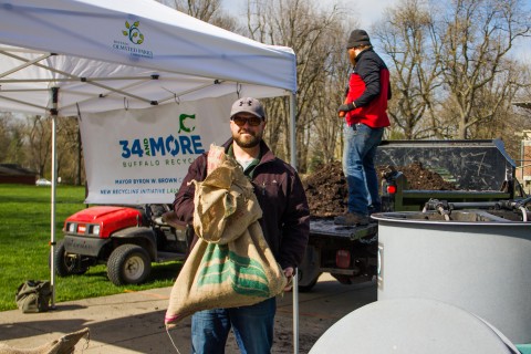 Adam Kneis from the BOPC holding a bag of compost before it was given out to those interested