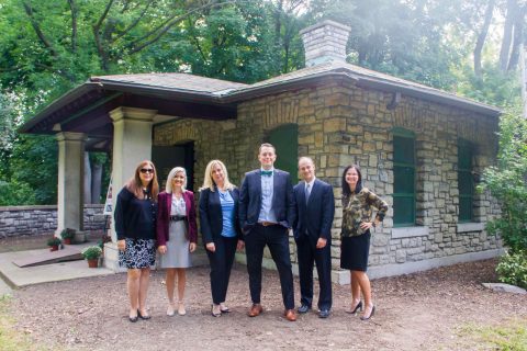 Rumsey Shelter Restoration 3: Members of the Bank of America team stand in front of the Rumsey Shelter, which will be restored thanks to a grant from Bank of America with matching funds provided by the Buffalo and Erie County Greenway Fund
